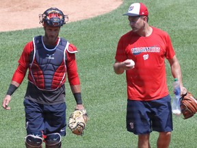 Washington Nationals relief pitcher Daniel Hudson (R) talks with Nationals catcher Yan Gomes (L) after a throwing session on day three of NationalsÕ workouts at Nationals Park.