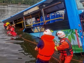 Rescuers work after a bus plunged into a lake in Anshun in China's southwestern Guizhou province on July 7, 2020.