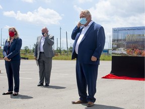 Ontario Premier Doug Ford (centre) attends a press availability in Marham, Ontario on Friday July 24, 2020.