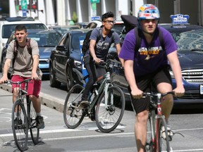 Cyclists make their way along Laurier Avenue.