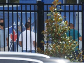 Blue Jays players hang out at the team’s spring training facility in Dunedin, Fla., waiting to undergo COVID-19 testing.