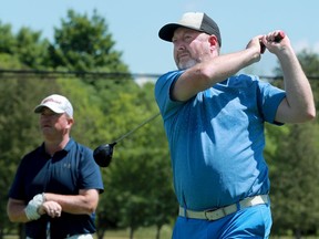 Two-time A division champion Marty McCaffrey tees off as Terry Brannan looks on.  The Ottawa Citizen Golf Championship golf tournament got underway Friday at the Mississippi Golf Club in Almonte.