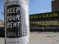 A sign publicizing a rent strike is fixed to a light pole.