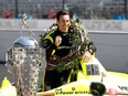 Simon Pagenaud poses with his car and the Borg Warner Trophy during a photo shoot after the 103rd Running of the Indianapolis 500 at Indianapolis Motor Speedway.