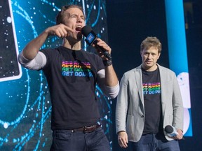 Craig Kielburger and his brother Marc Kielburger (right) take to the stage as WE Day takes place at Canadian Tire Centre in Ottawa.
