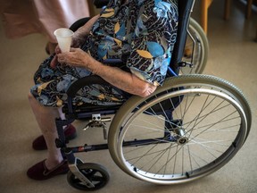 FILE: A senior in a wheelchair is pictured with a glass of water.