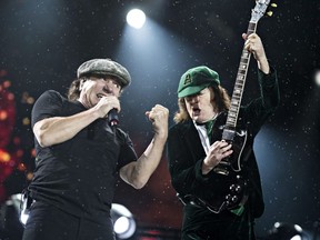 Brian Johnson, left, and Angus Young, right, of AC/DC perform at Commonwealth Stadium in Edmonton, Alta. on Sept. 20, 2015.