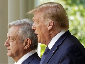 Mexico's President Andres Manuel Lopez Obrador walks with U.S. President Donald Trump as they arrive at a signing ceremony in the Rose Garden at the White House in Washington July 8, 2020.