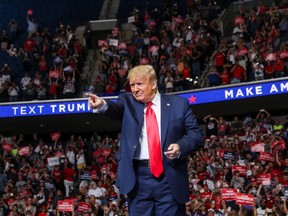U.S. President Donald Trump points at the crowd as he enters his first re-election campaign rally in several months in the midst of COVID-19, at the BOK Center in Tulsa, Okla., Saturday, June 20, 2020.