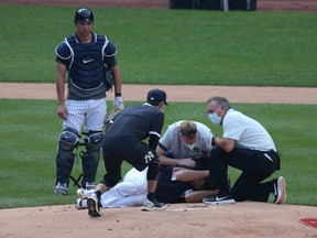 New York Yankees starting pitcher Masahiro Tanaka is tended to after being struck in the head by a line drive during workouts at Yankee Stadium.