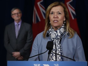 Ontario Chief Medical Officer of Health Dr. David Williams looks on as Ontario Health Minister Christine Elliott speaks during the daily briefing at Queen's Park in Toronto on June 18, 2020.
