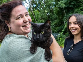 Carrie Haber welcomes Kudzu home after he was lost for more than a week. Chloe Perl, right, had spotted him and posted a notice on a Facebook community page.