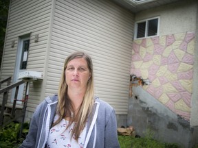 Melissa Lepage in front of her flood-damaged home in Constance Bay, which has been condemned, Thursday August 20, 2020. Lepage is in a battle with her insurance provider, also, her husband is battling early onset dementia.