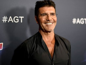 Television personality Simon Cowell reportedly broke his back while testing an electric bicycle at his home in Malibu on Saturday, according to multiple reports. He is said to be doing fine.