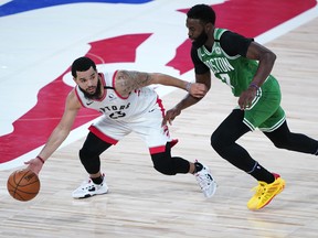 Raptors guard Fred VanVleet tries to get around Boston's Jaylen Brown, which isn't an easy task, on Friday.