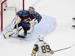 Alex Tuch of the Golden Knights scores the game-winning goal against Philipp Grubauer of the Avalanche during overtime on Saturday in Edmonton.