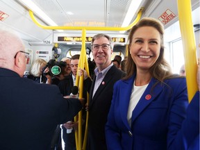 Jim Watson and Caroline Mulroney (R) enjoy the LRT launch, September 14, 2019.