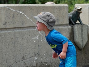 Young Dominik Kasztelam literally sucks up the chilly water at the splash pad in Barrhaven.