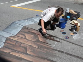 François Pelletier is a sidewalk artist painting on Bank Street.