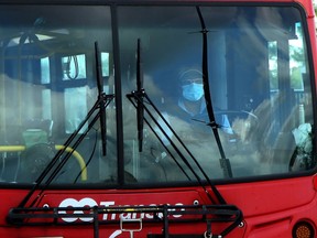 An OC Transpo bus driver wearing a mask.
