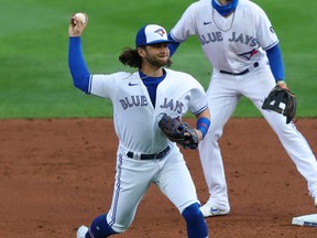Toronto Blue Jays' Bo Bichette, seen here throwing out a Tampa Bay baserunner on Saturday, is out with a knee injury.
