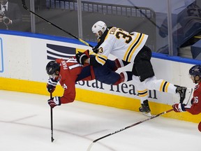 Boston Bruins defenceman Zdeno Chara, right, knocks down Washington Capitals forward Richard Panik during the first period of the Eastern Conference qualifications at Scotiabank Arena in Toronto, Aug. 9, 2020.