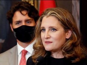 Deputy Prime Minister and Finance Minister Chrystia Freeland speaks to reporters next to Prime Minister Justin Trudeau on Parliament Hill in Ottawa, Aug. 18, 2020.
