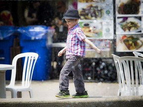 Five-year-old Desmond Hersak walks around the fountain in Confederation Park in the food area of the TD Ottawa Jazz Festival on Saturday.