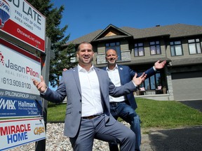 Remax broker Jason Pilon (right) and sales rep Erik Faucon in front of the home at 119 Saphir Ave.