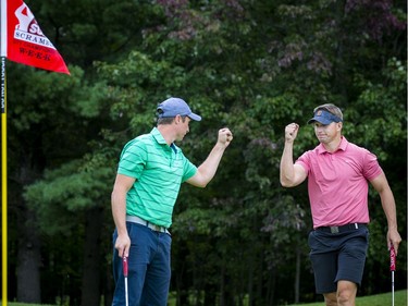 Joey Publow (left) and Dave Petters celebrate a shot at the Ottawa Sun Scramble on Sunday.
