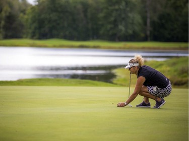 Marie Lusson lines up a putt.