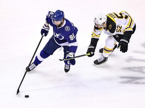 Nikita Kucherov of the Tampa Bay Lightning is pursued by Boston Bruins’ Sean Kuraly during the first period in Game 2 of their second-round playoff series on Tuesday night at Scotiabank Arena in Toronto.