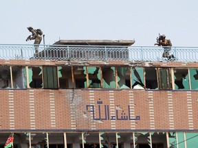 Afghan security forces take position on a building where the attackers were hiding after an attack on a jail compound in Jalalabad, Afghanistan August 3, 2020.