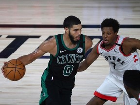 Aug 30, 2020; Lake Buena Vista, Florida, USA; Boston Celtics forward Jayson Tatum dribbles against Toronto Raptors guard Kyle Lowry during the third quarter in game one of the second round of the 2020 NBA Playoffs at The Field House.
