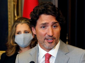 Prime Minister Justin Trudeau speaks to reporters next to Canadian Deputy Prime Minister and Finance Minister Chrystia Freeland on Parliament Hill on Aug. 18, 2020.