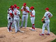 Cardinals starting pitcher Carlos Martinez (18) and infield players talk during the first inning against the Twins at Target Field, in Minneapolis, Tuesday, July 28, 2020.