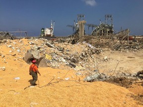A man walks near rubble at the site of Tuesday's blast, at Beirut's port area, Lebanon August 7, 2020.