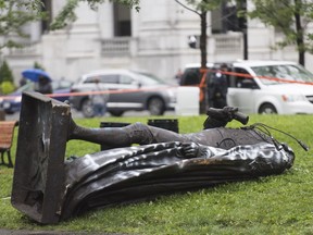 The statue of Sir John A. MacDonald is shown torn down following a demonstration in Montreal on Saturday where they protested to defund the police with a goal to end all systemic racism within all sectors of the Canadian government.