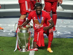 Soccer Football - Champions League - Final - Bayern Munich v Paris St Germain - Estadio da Luz, Lisbon, Portugal - August 23, 2020  Bayern Munich's Alphonso Davies poses as he celebrates winning the Champions League with the trophy, as play resumes behind closed doors following the outbreak of the coronavirus disease (COVID-19)