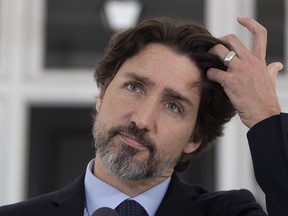 CP-Web. Prime Minister Justin Trudeau adjusts his hair during a daily news conference outside Rideau Cottage in Ottawa, Friday May 22, 2020. THE CANADIAN PRESS/Adrian Wyld ORG XMIT: ajw101