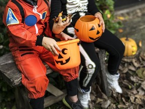 Little children trick-or-treating on Halloween.