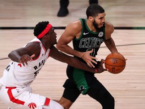 Raptors’ Pascal Siakam, who did not play well in the Raptors’ seven-game ouster at the hands of the Boston Celtics, reaches in to try and stop Jayson Tatum on Friday night.