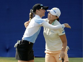 Mirim Lee (right) of South Korea is congratulated by Nelly Korda after Lee defeated Korda and Brooke Henderson in a playoff to win the ANA Inspiration at the Dinah Shore course at Mission Hills Country Club on Sunday in Rancho Mirage, California.