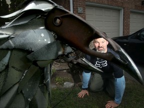 A file photo shows David Harries with the sculpture entitled Crowvid-19.