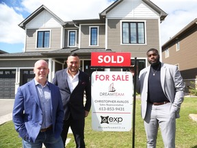 Christo Bilukidi, right, poses for a photo with real estate partners Ryan Lafrange, left, and Chris Avalos on Friday.
