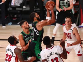 Boston Celtics forward Jayson Tatum (0) moves to the basket against Miami Heat guard Andre Iguodala (28) forward Bam Adebayo (13) and guard Duncan Robinson (55) during the second half in game five of the Eastern Conference Finals of the 2020 NBA Playoffs at AdventHealth Arena, Sept. 25, 2020.