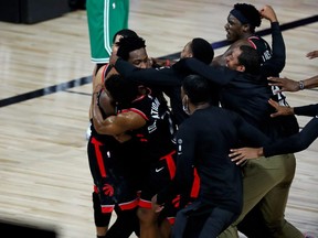 Raptors forward OG Anunoby is mobbed by teammates after making the game winning three point basket to defeat the Celtics in Game 3 of the second round of the 2020 NBA Playoffs at ESPN Wide World of Sports Complex, in Lake Buena Vista, Fla., Thursday, Sept. 3, 2020.