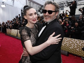 Joaquin Phoenix and Rooney Mara embrace on the red carpet during the Oscars arrivals at the 92nd Academy Awards in Hollywood February 9, 2020.