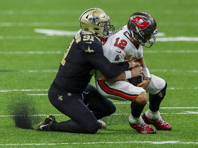 New Orleans Saints defensive end Trey Hendrickson (91) sacks Tampa Bay Buccaneers quarterback Tom Brady (12) during the second quarter at the Mercedes-Benz Superdome in New Orleans on Sept. 13, 2020.