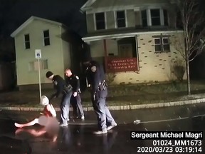 This March 23, 2020, image taken from police bodycam video released by the Rochester, New York, Police Department, shows police arresting Daniel Prude after allegedly putting a hood on him.